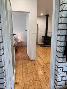 an open door to a living room with a wood stove at King Edi Cottage in Edi +4 photos