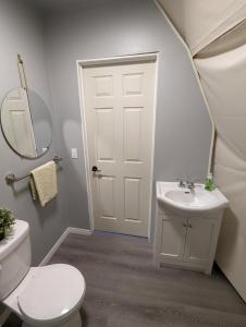 a bathroom with a white toilet and a sink at Fundy Spray Campground in Smiths Cove