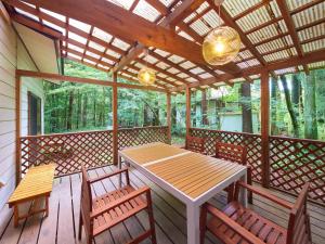 那須 - Nasu 369 MOMURA Cottage - ペット可 في ناسوشيوبارا: شرفة خشبية عليها طاولة وكراسي