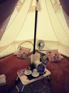 een tafel met een theeset bovenop een tent bij The Backyard Glamping Cameron Highlands in Tanah Rata