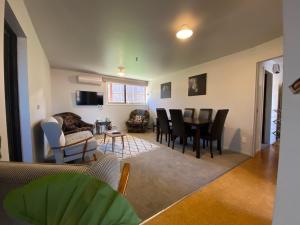a living room with a table and chairs at 43b Conical Hill Road in Hanmer Springs