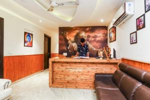 a bar in a room with a painting on the wall at OYO Flagship Hotel Shri Sai in New Delhi