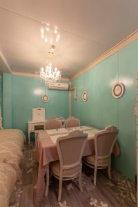 a dining room with a table and chairs and a chandelier at SakurA - Vacation STAY 18991v in Nagoya