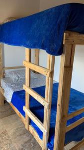 a bunk bed with a blue blanket on it at Villa Claudia in Villa de Leyva
