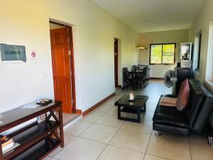 a living room with a couch and a table at House of Garden Resort in Chiang Rai