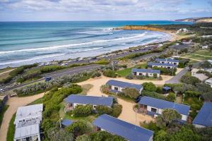 an aerial view of a beach with houses and the ocean at Torquay Foreshore Caravan Park in Torquay