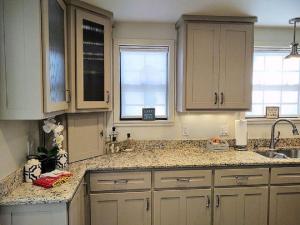 a kitchen with white cabinets and granite counter tops at #10-Amazing Three Bedroom Lake House-Pet Friendly in Hot Springs +19 photos