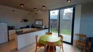 a kitchen with a table and a small table and chairs at Lucero in Mar Azul