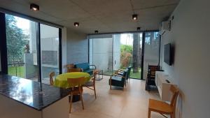 a living room with a counter and some chairs at Lucero in Mar Azul