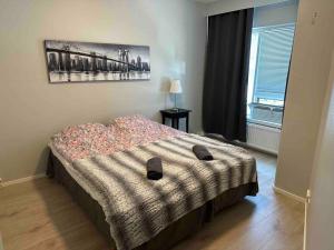 a bedroom with a bed with a blanket on it at Utopia 1BR and sauna in Tornio