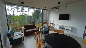 a living room with a tv and a table and chairs at Nereida in Mar Azul