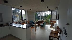 a kitchen and living room with a counter and chairs at Nereida in Mar Azul