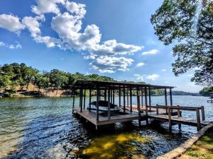 a dock on a lake with a boat in the water at #10-Amazing Three Bedroom Lake House-Pet Friendly in Hot Springs