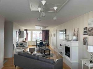 a living room with a couch and a fireplace at Luxury 2-3BR Tornio city Apparment in Tornio