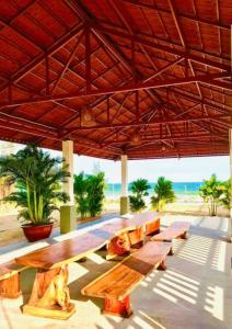 einen Picknicktisch unter einem Pavillon am Strand in der Unterkunft 24 Gold Homestay in Phan Thiet