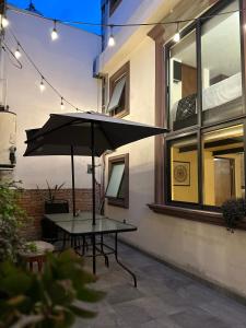 a table with an umbrella on a patio at Hotel Del Valle in Tecozautla