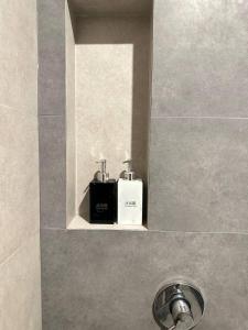 a bathroom sink with a soap dispenser on a shelf at Laluna Guesthouse in Siem Reap