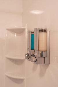a wall mounted soap dispenser on a wall at Motel Torrey in Torrey +18 photos