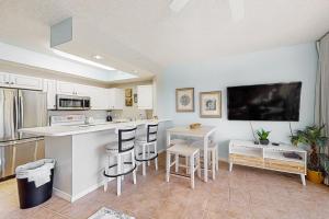 a kitchen with a counter and a kitchen island with stools at Destin West Resort - Gulfside 207 in Fort Walton Beach