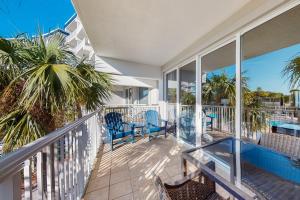 a balcony with a table and chairs and a view of the ocean at Destin West Resort - Gulfside 207 in Fort Walton Beach