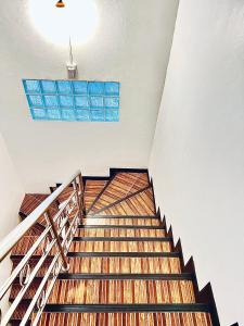 a staircase in a building with a blue window at 88 House Patong in Patong Beach