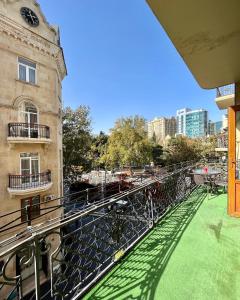 einen Balkon eines Gebäudes mit grünem Rasen in der Unterkunft Nizami Central Street Hotel in Baku
