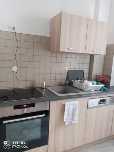 a kitchen with a sink and a stove at Grand appartement au coeur de Strasbourg in Strasbourg