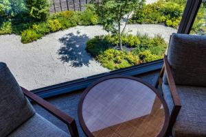 two chairs and a table in front of a window at Hotel Okura Kyoto Okazaki Bettei -Age Requirement 12 over- in Kyoto
