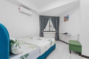 a bedroom with a bed and a window and a chair at Bukit Bintang Times Sq With 3 Bedroom 74 in Kuala Lumpur