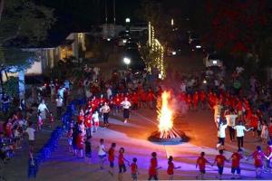 a crowd of people standing around a fire in the street at Nha Khach Hai Quan in Ðố Sơn