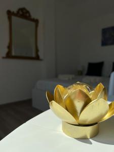 a gold flower bowl sitting on top of a table at Fior di Loto Suite - Lingotto in Turin
