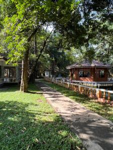 a path in a park next to a house at Surya Eco and Wedding Resort in Trichūr