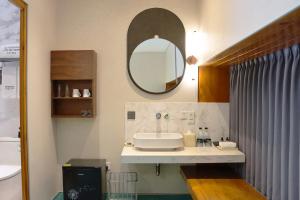 a bathroom with a sink and a mirror at The Sifang Hotel Nanjing, Autograph Collection in Nanjing