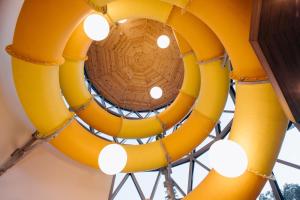 a large yellow chandelier hanging from a ceiling at HOTEL CRYSTAL WELLNESS & SPA superior in Sovata