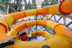 an orange inflatable slide in a building at HOTEL CRYSTAL WELLNESS & SPA superior in Sovata