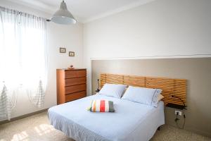 a bedroom with a large bed with a wooden headboard at Casa stella in San Lorenzo al Mare