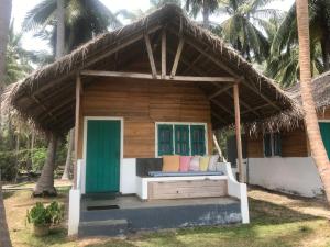 a small house with a thatched roof at Salt Bay Kite Resort in Kalpitiya