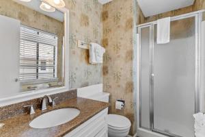a bathroom with a sink and a shower at Bayview East & West in Holden Beach