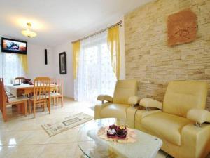 a living room with a couch and a dining room at domek PERKUN in Pierkunowo