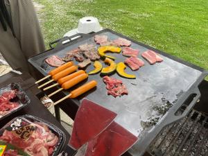 a grill with some meat and vegetables on it at Shinshu Wakaho Gibier B&B in Nagano