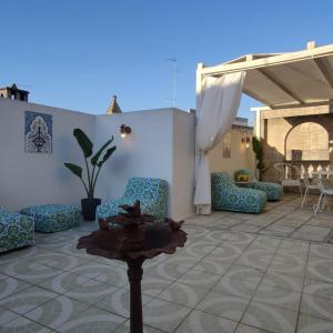 a patio with blue chairs and a table at Suite San Giovanni in Torre Santa Susanna