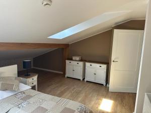 a attic bedroom with a bed and a skylight at Apartamenty Kopernika 14 in Toruń