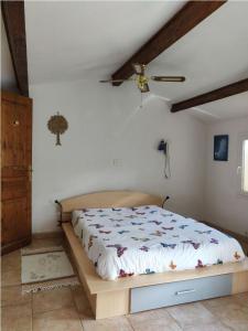 1 cama en un dormitorio con ventilador de techo en Villa en Trets