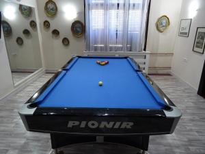 a pool table in a room with a pool ball at Mia Casa in Novi Sad