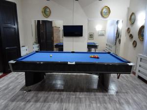 a pool table in the middle of a room at Mia Casa in Novi Sad