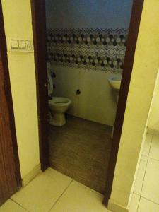 a bathroom with a toilet and a sink at OYO Hotel Ambar Inn in Phagwāra