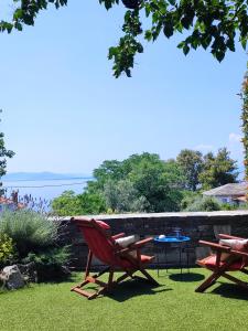 卡多加茲亞的住宿－HIsun 4 Seasons Seaside Luxurious Maisonette，两把红色椅子和一张桌子在院子里