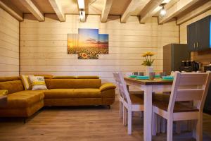 a living room with a table and a couch at Siedlisko Malechowo in Ustronie Morskie