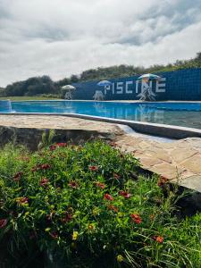 a swimming pool with a water park with flowers at Étage RDC villa vu sur mer avec jardin in El Jadida