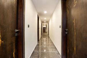 a corridor of a hotel with doors at OYO Flagship Star Stay in New Delhi